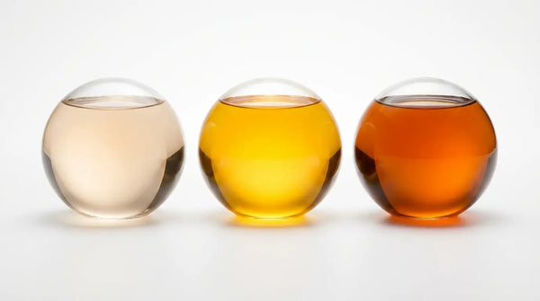 Three glass spheres with deepening amber liquid, visualizing Benfotiamine dosage levels from maintenance to therapeutic.