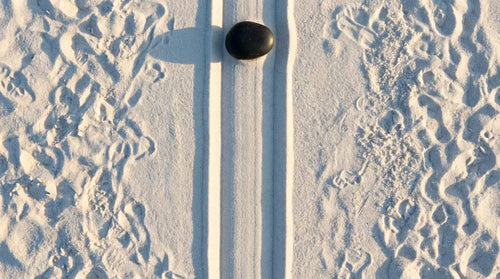 Zen garden sand with a single perfect path raked through chaos, visualizing the mental clarity and focus achieved through mindfulness.
